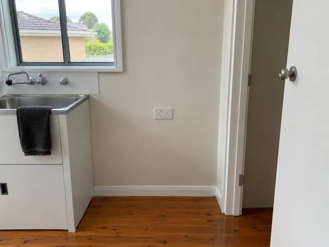 Kitchen wall with a double power point beside a sink and doorway in a home in Killarney Vale